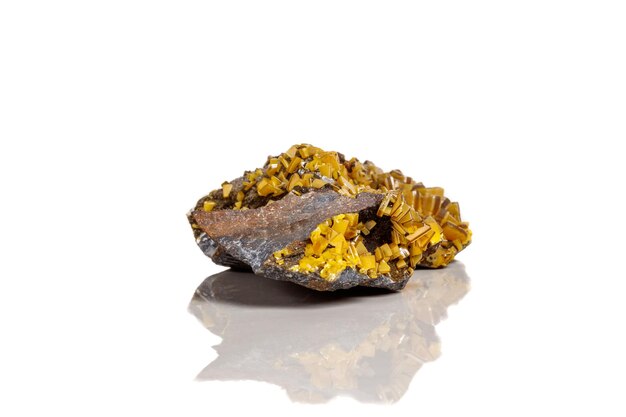 Photo macro mineral stone yellow wulfenite on a white background