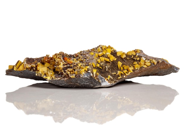 Photo macro mineral stone yellow wulfenite on a white background