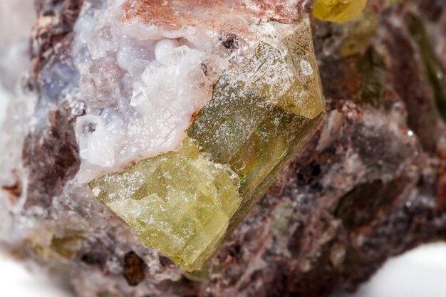 Macro mineral stonexAGolden Apatite on a white background