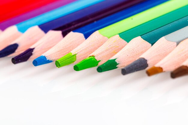 Macro multicolored pencils on a white background