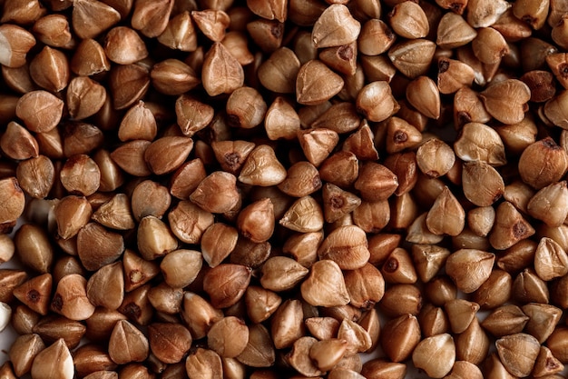 Macro photo of buckwheat groats Many small objects close up Healthly food