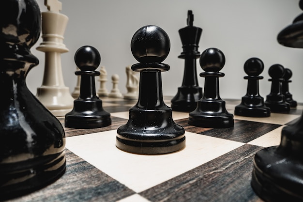 Macro photo of chess pieces on a wooden chess board