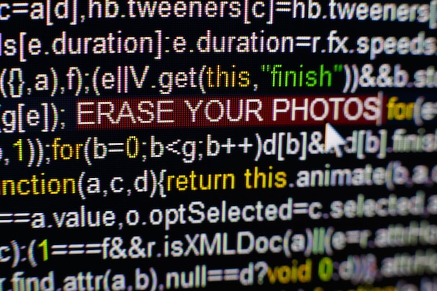 Macro photo of computer screen with program source code and highlighted erase your photos