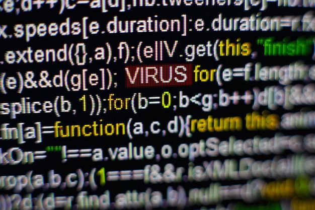 Макрофото экрана компьютера с исходным кодом программы и выделенной надписью VIRUS в середине Скрипт на экране с вирусом в нем Концепция кибербезопасности Технологический фон