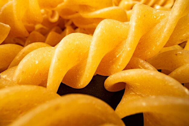 Macro photo of dry heap of fusilli pasta close up