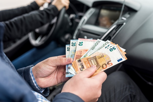 Macro photo of male hands holding euro banknotes