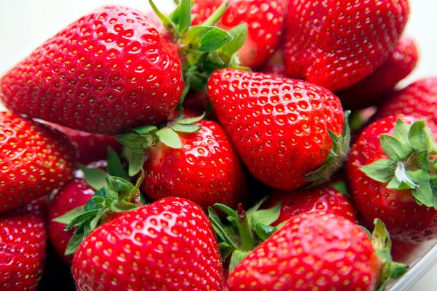 Macro photo of a ripe red large strawberry with a small depth of field