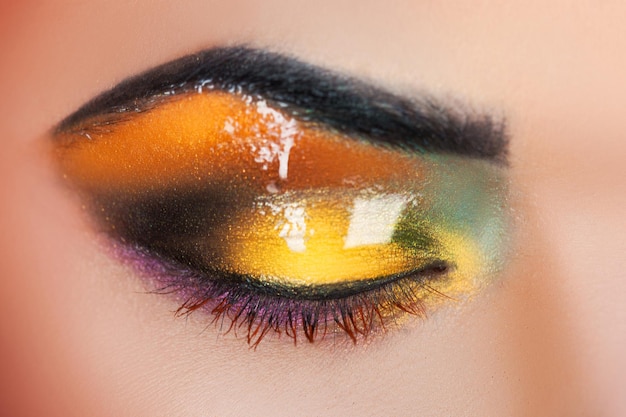 Macro photo of woman's closed eye with make up in studio