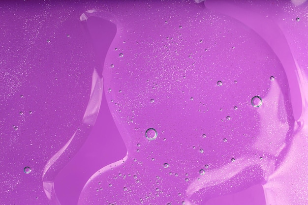 Photo macro photography of bubbly smear on purple background