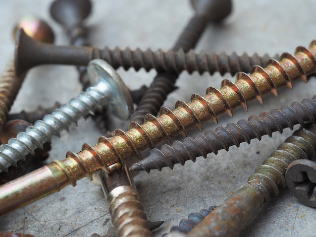 Macro photography of screws. Industrial background. Old rusty screws close up, selective focus