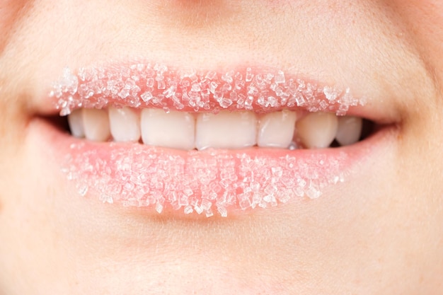 Macro photography of women's lips with sugar scrub