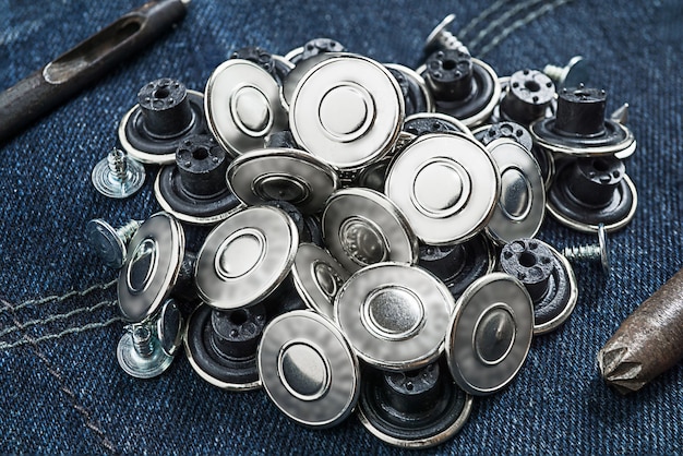 Macro picture of pile replae silver button jean on denim farbic