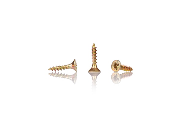 Macro screw of golden color on a white background