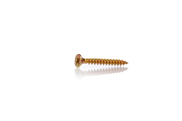 Macro screw of golden color on a white background