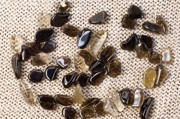 Macro shooting of collection natural rock set of morion smoky quartz gem mineral stones on grey background