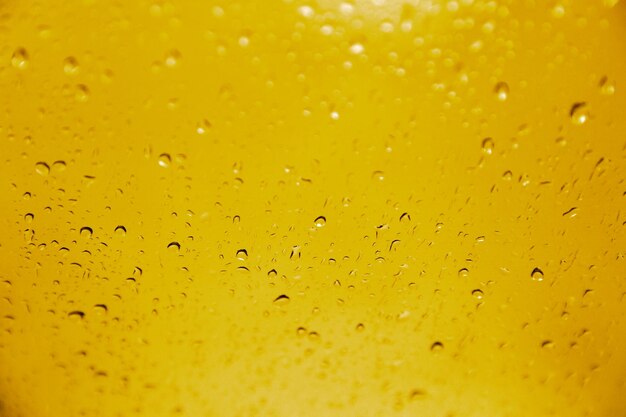 Macro shot of clear water droplets on brown surface