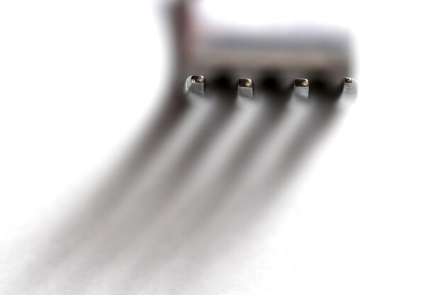 Photo macro shot of fork on white background