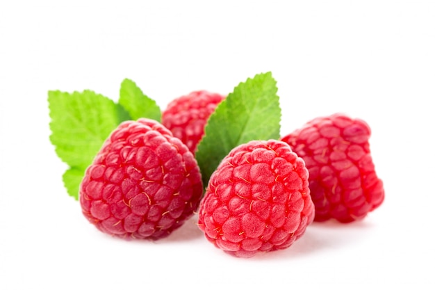 Macro shot of fresh raspberries with leaves isolated