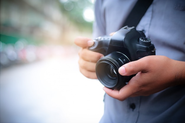 macro shot of man hands holding photo camera