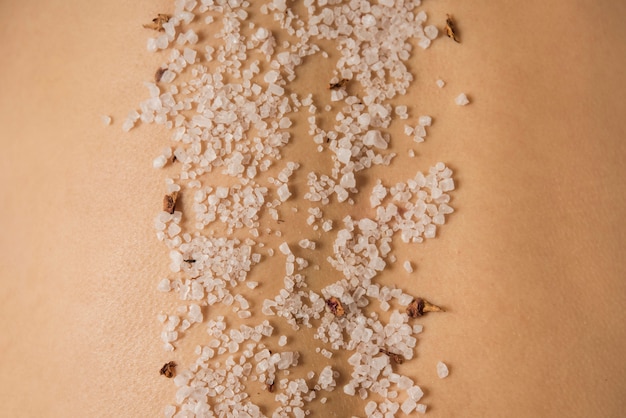 Macro shot of sea salt on woman's back