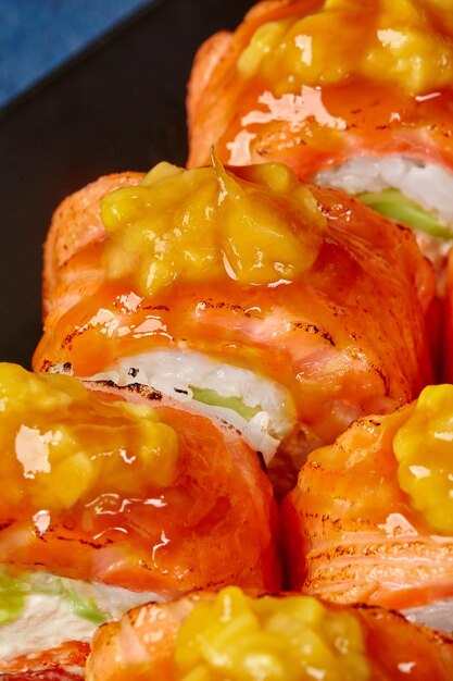 Macro shot of uramaki rolls with seared salmon and caramelized mango