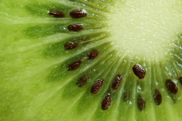 Macro shot of vibrant green fresh and juicy of cut ripe kiwi fruit for texture and background