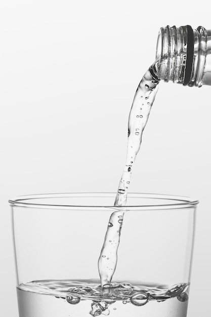 Macro shot of water pouring into a glass