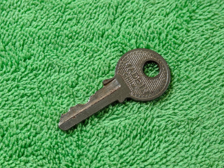 Photo macro of silver key on green background