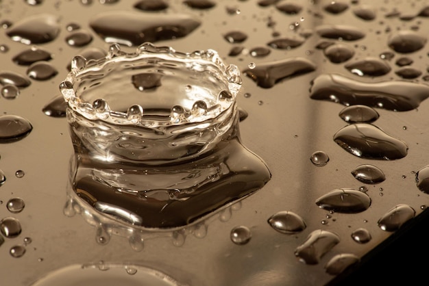 Macro splash macro photo of a drop of water falling on a reflective surface selective focus