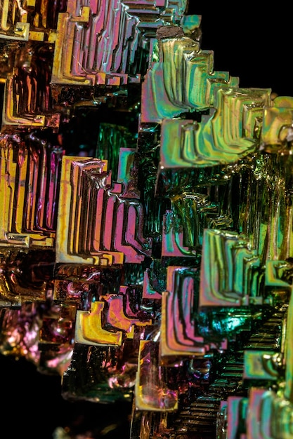 Macro of the stone bismuth mineral on a black background close up