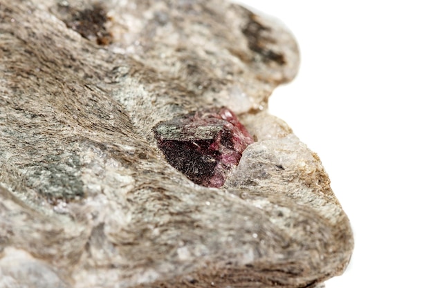 Macro stone Garnet mineral in rock on a white background