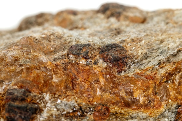 Macro stone Garnet mineral in rock on a white background