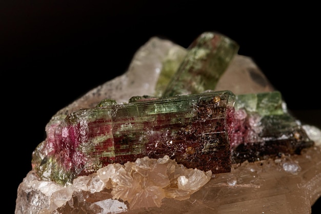 Macro stone tourmaline mineral on a black background close up