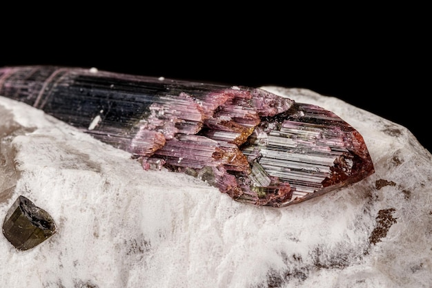 Macro stone tourmaline mineral on a black background close up