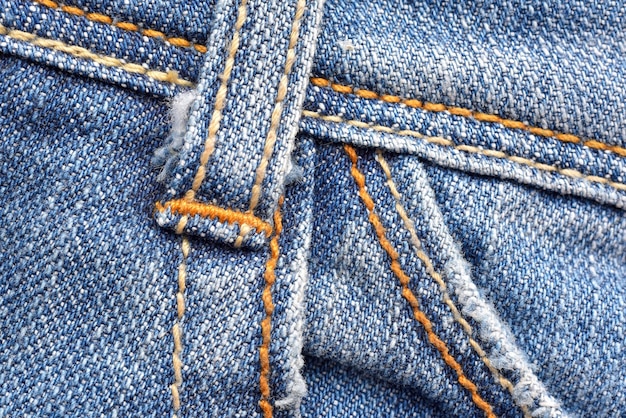 Macro van riemlus jeans broek Denim structuurpatroon Close up van steek en stof detail achtergrond