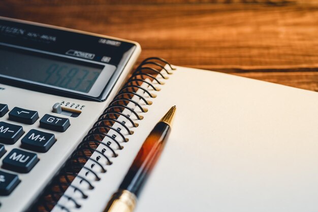 macro view of a calculator and pen on notebook