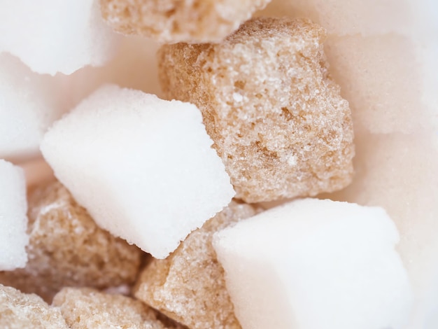 Photo macro view of mixed raw lump sugar brown and white sugar cubes selective focus