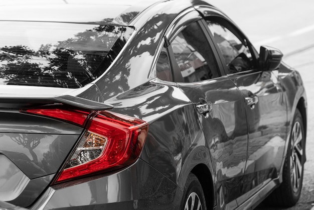 Photo macro view of modern silver car xenon lamp taillight, bumper, rear trunk lid. exterior of a modern car