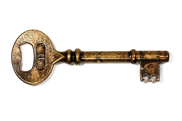 Macro view of an old golden key with the number 11 isolated on a white background.
