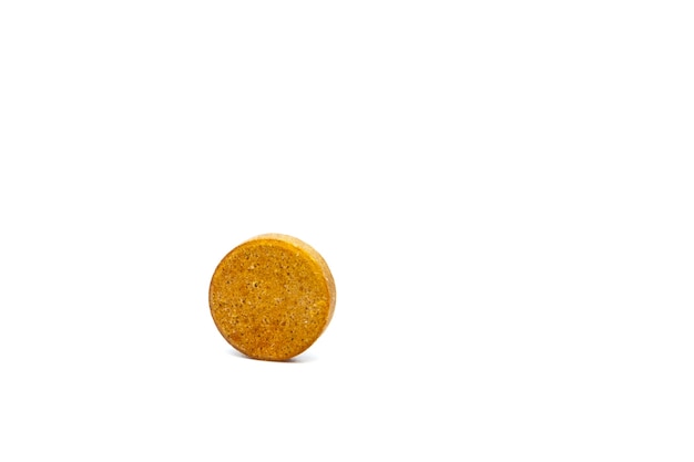 Macro view of pill or tablet isolated over white wall.