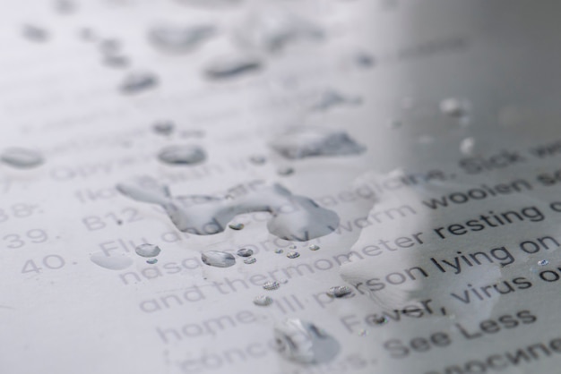 The macro view of water bubbles on the pixel screen of the gadget surface with text, technology colnept