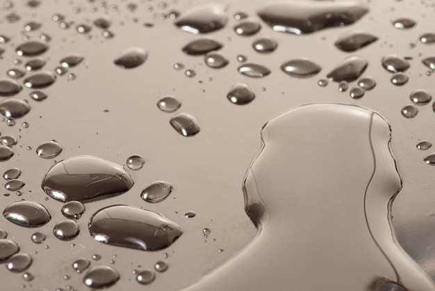 Macro water drops macro photo of water drops on a reflective\
surface selective focus