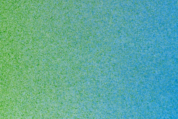 Macrofotografie van groene en blauwe spuitverf op wit papier