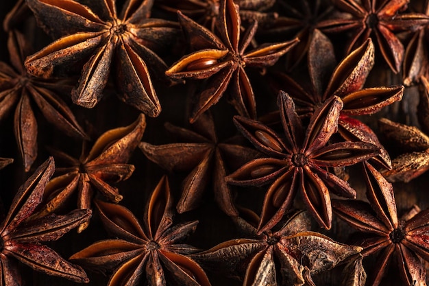 Macrophotography of star anise on a wooden background. brown spice star anise is close