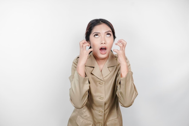 Mad civil worker woman wearing a brown uniform feeling so stressed Indonesian government employees overworked concept