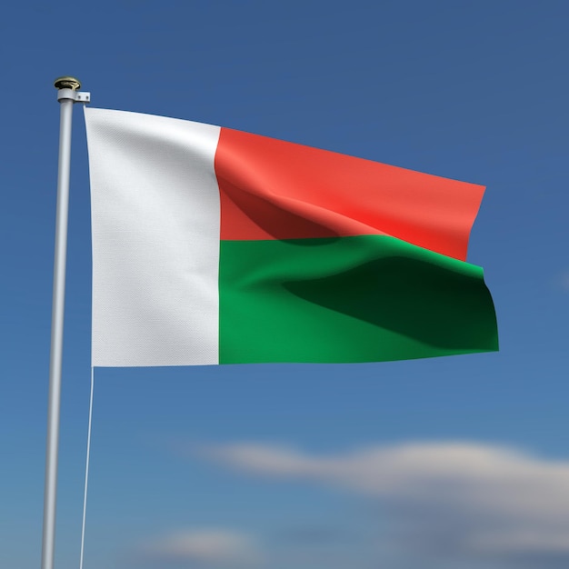 The Madagascar Flag is waving in front of a blue sky with blurred clouds in the background