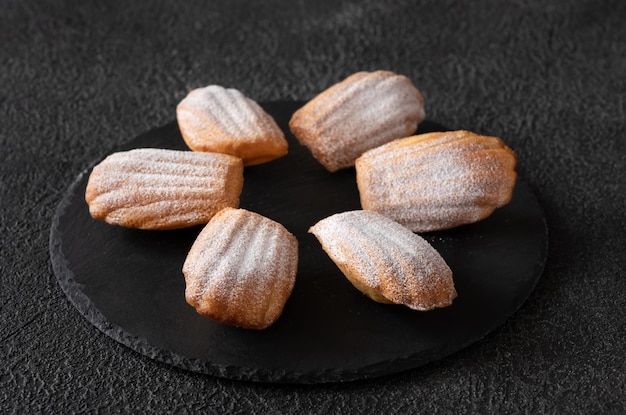 Madeleines - French small sponge cakes on the stone board