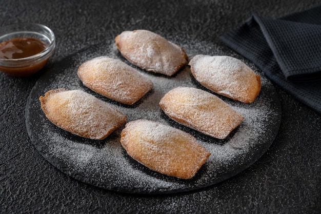 Madeleines - French small sponge cakes on the stone board