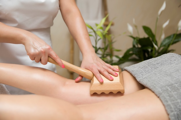Maderotherapy anti-cellulite massage with wooden roller massager