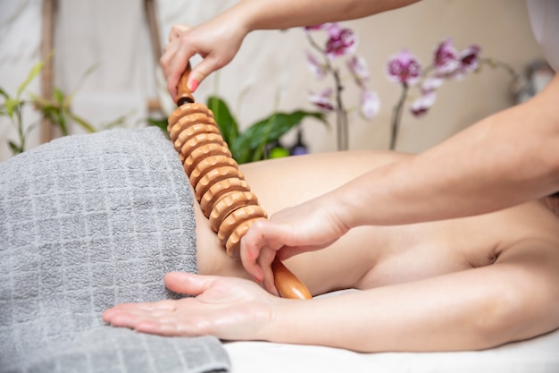 Maderotherapy anti-cellulite massage with wooden roller massager